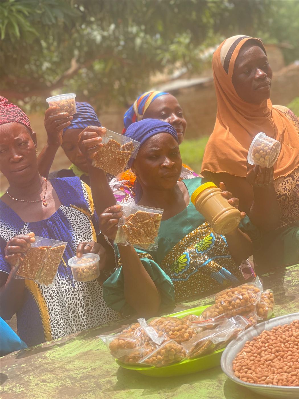 Smiling women holding Influx groundnut products